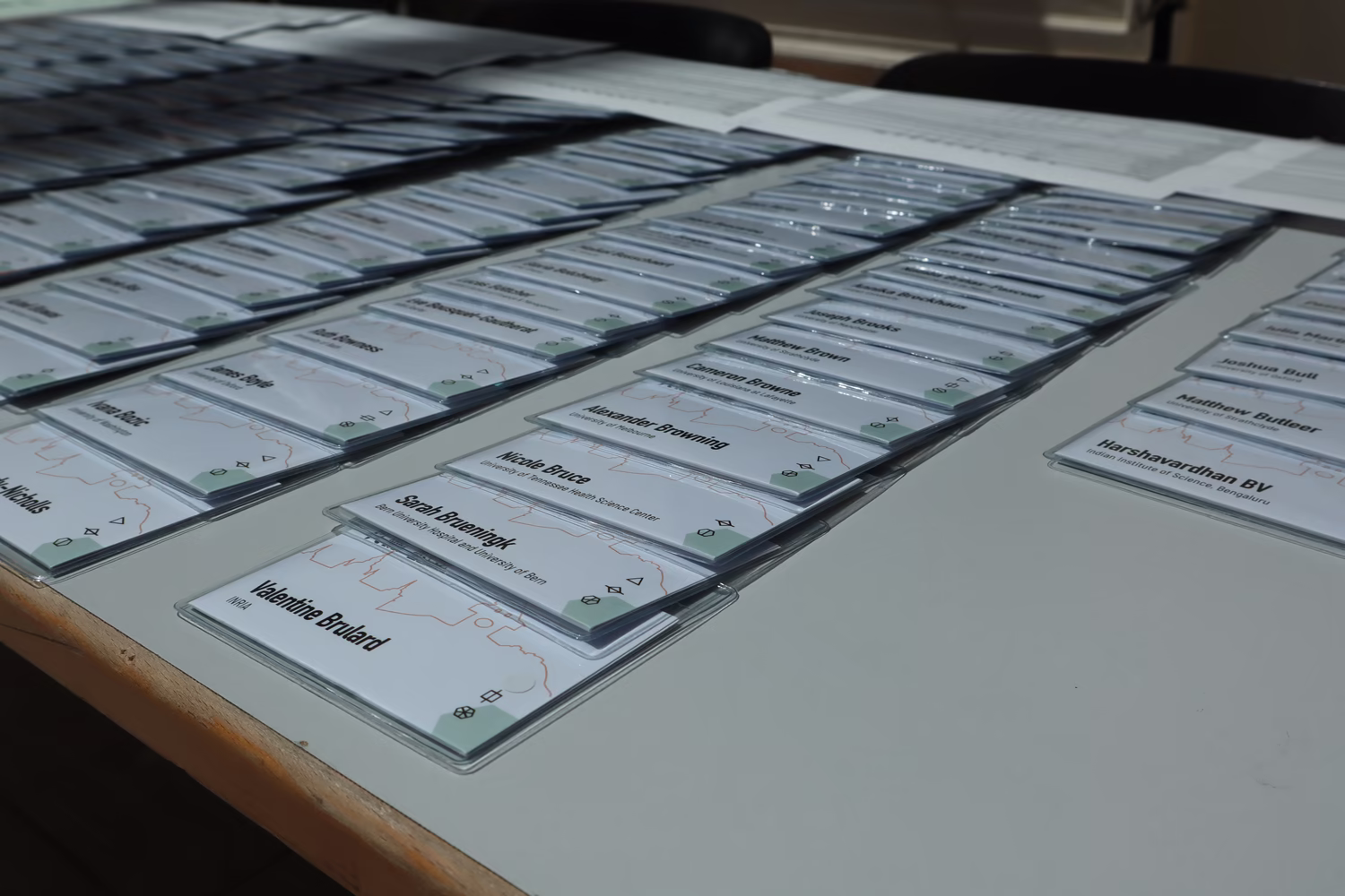 Many name tags neatly laid out on a table